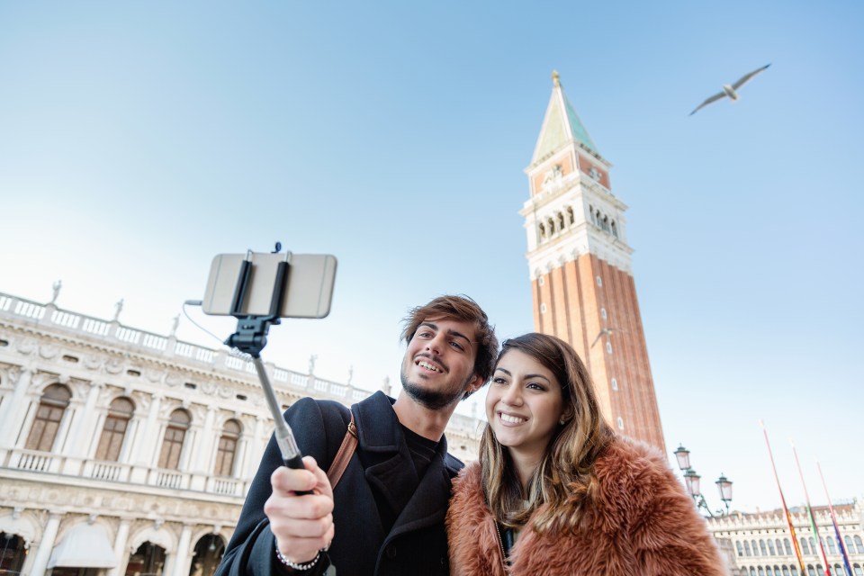 Couple taking selfie in Piazza San Marco Venice