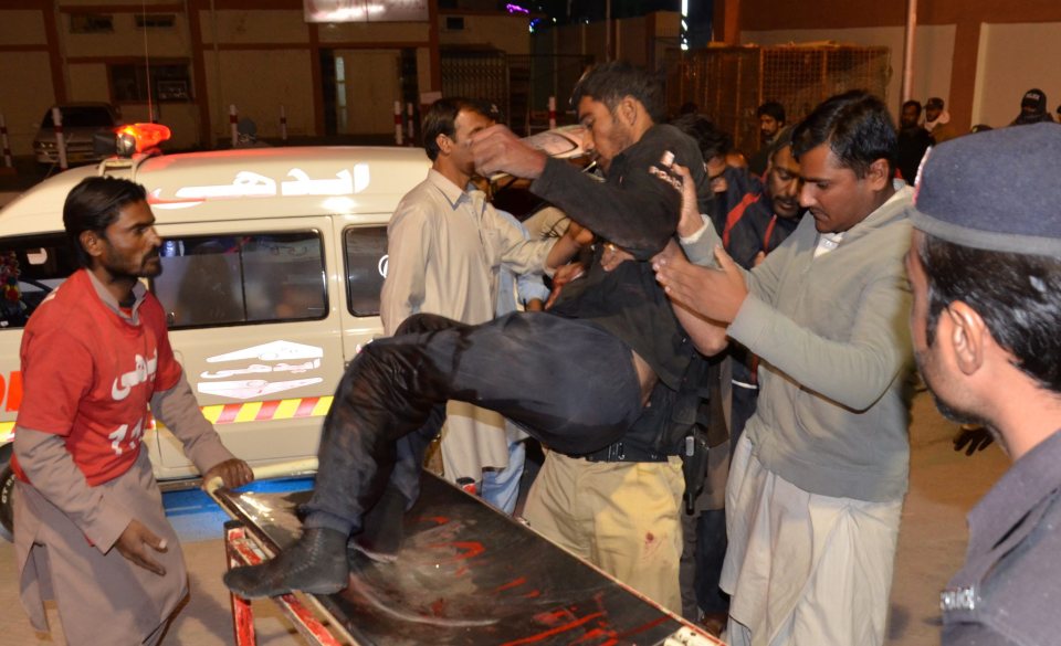  A police cadet injured during clashes with suspected militants is helped on to a stretcher