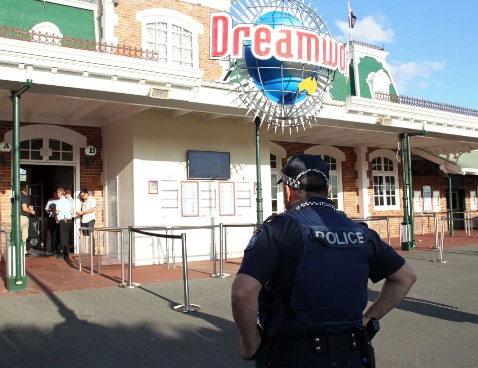  A police officer stands in front of the Dreamworld theme park