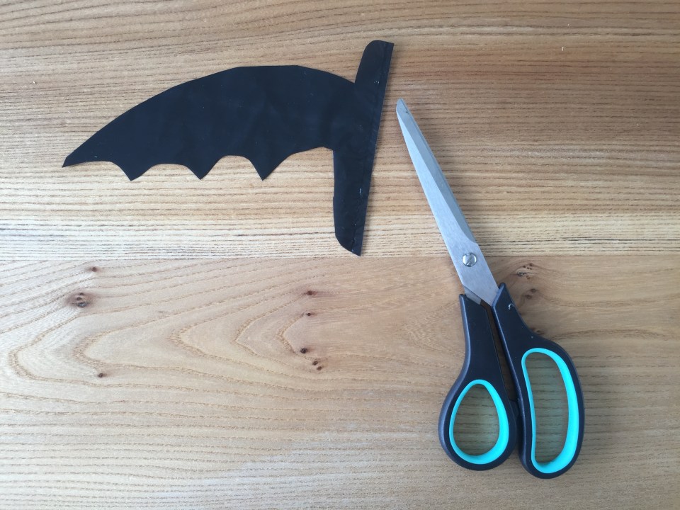  Stencil or cut freehand half a bat shape with the centre of your shape running along the fold line