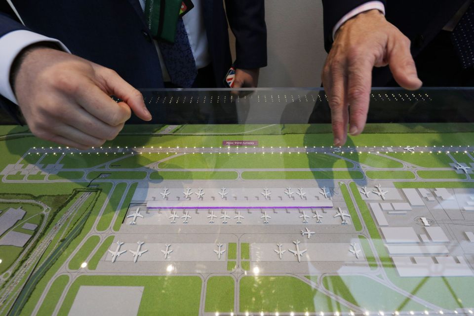 People look at a model of the proposed third runway in the Royal Suite of Heathrow Airport