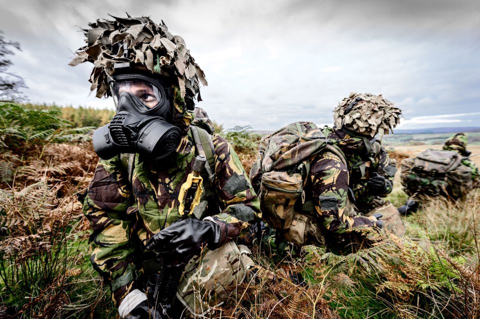 Cpl Timothy Jones is pictured crawling through the mud as the intensive army training is exposed in a series of photographs