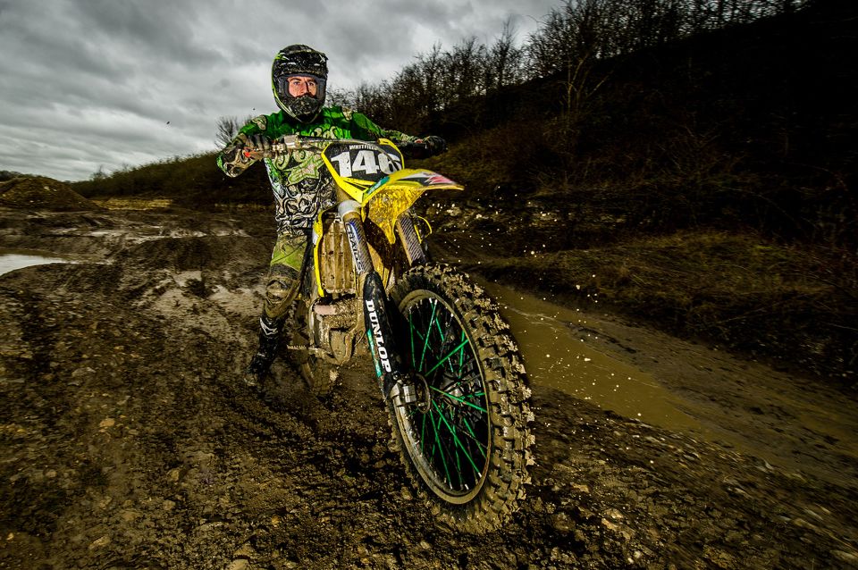  Sapper Anthony Gaunt of 299 Parachute Squadron, Royal Engineers tackling a wet and muddy course during a practice session before the Army Moto X championships