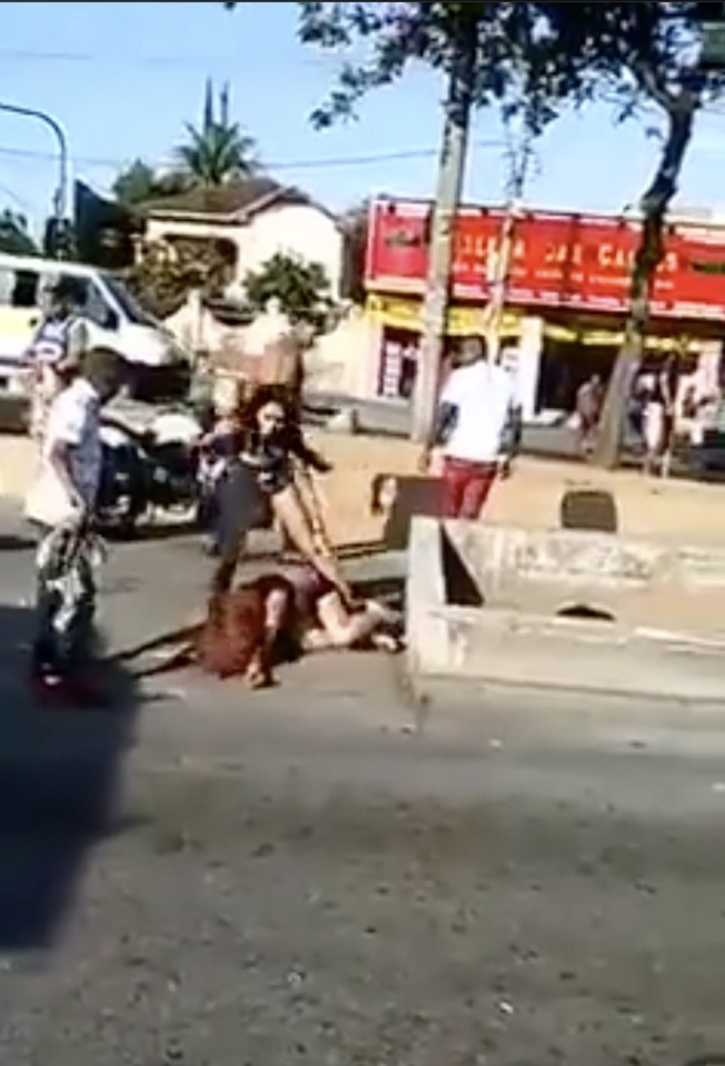  The woman was left cowering and unconscious in the street after the thugs left