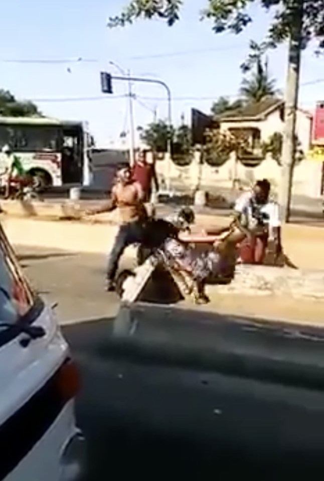  The brutal footage shows two men hurling a woman to the floor in the Brazilian street