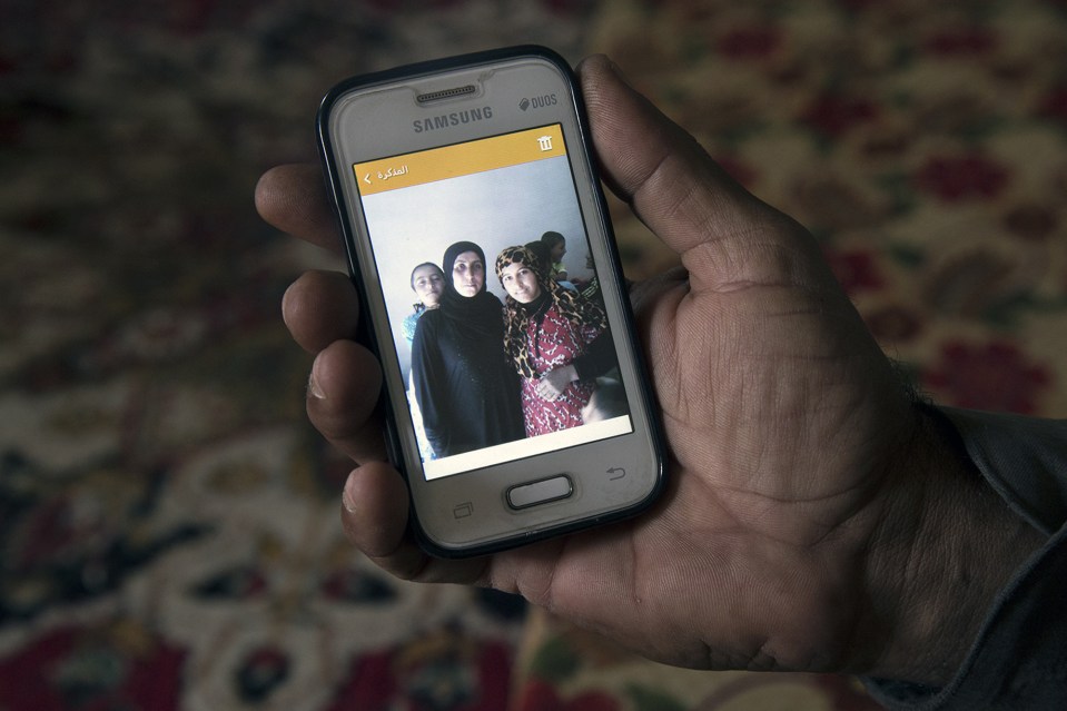  Dad Khaled Abdi shows a photograph of his daughter, 18, who was killed when a device exploded as they were returning to their house