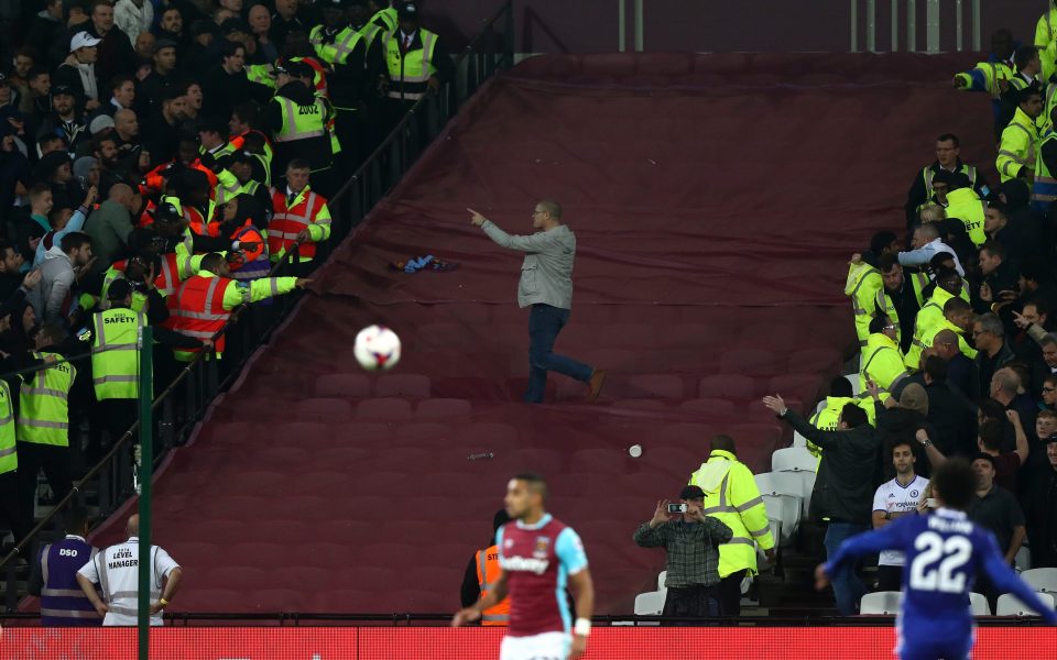 One ballsy supporter rushes into the middle of both sets of police 