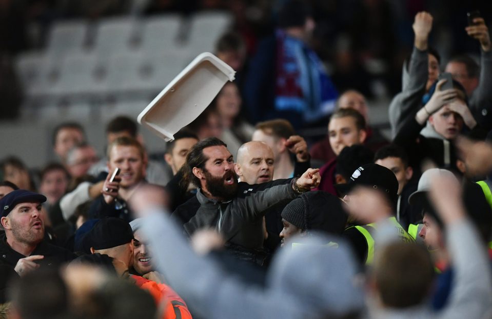  Chairs were ripped out and tossed into the crowd as West Ham and Chelsea fans clashed at the London Stadium