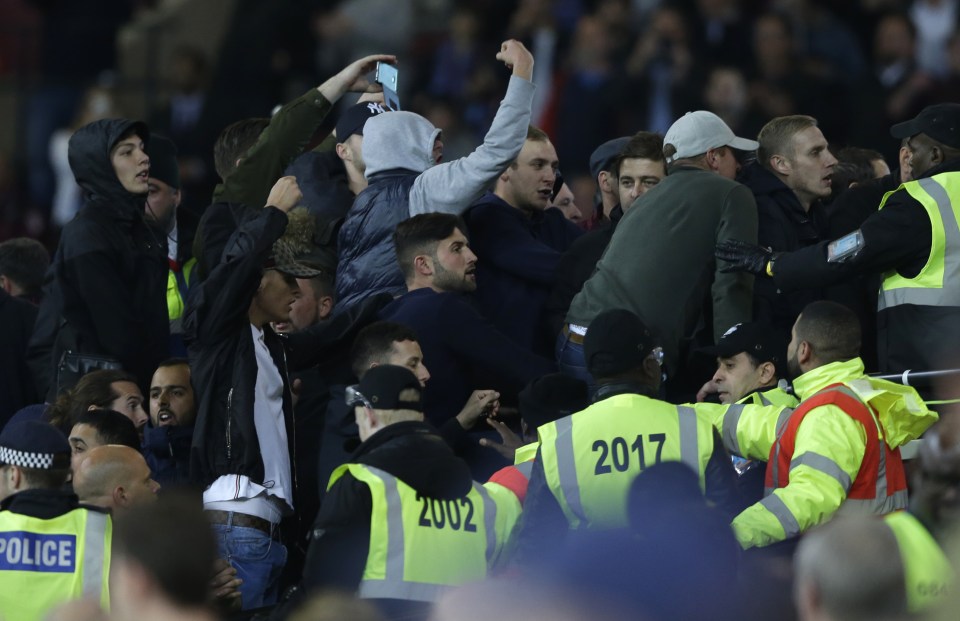  Rival supporters taunt each other and clash with stewards during EFL Cup clash