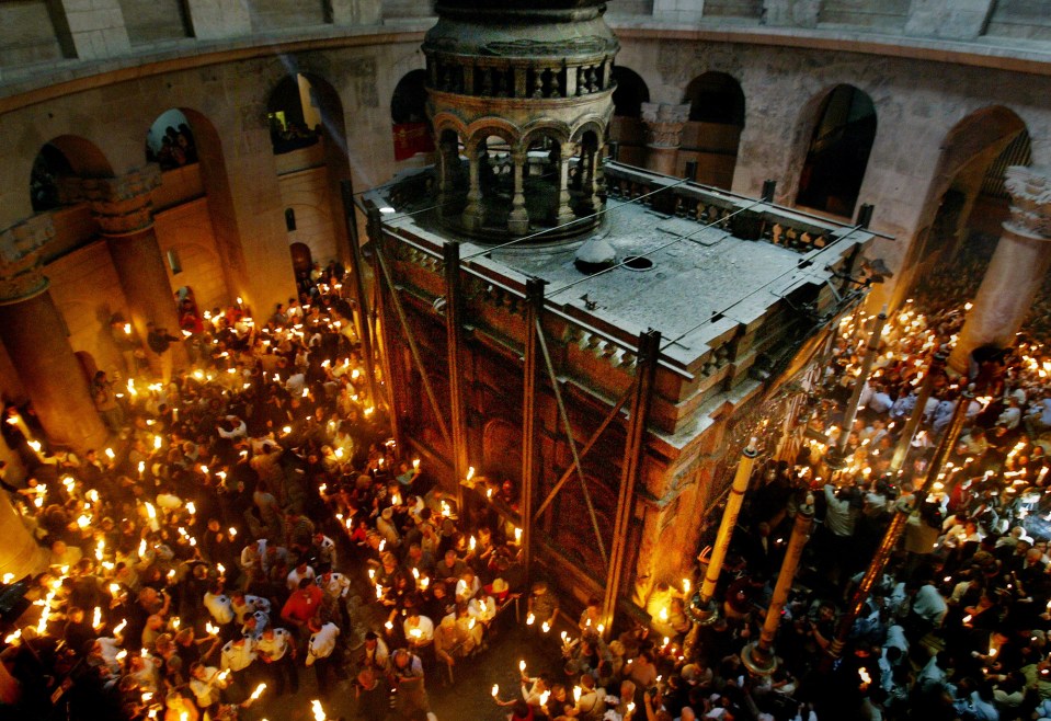  Awesome ... clergymen hold candles outside the Edicule, which has held the burial slab since Roman times