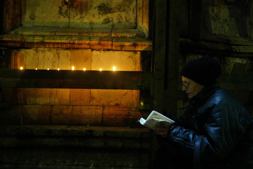  Tomb ... Site holds what is believed to be Christ's burial stone, pictured here in front of a worshipper, which has been revealed for the first time in centuries