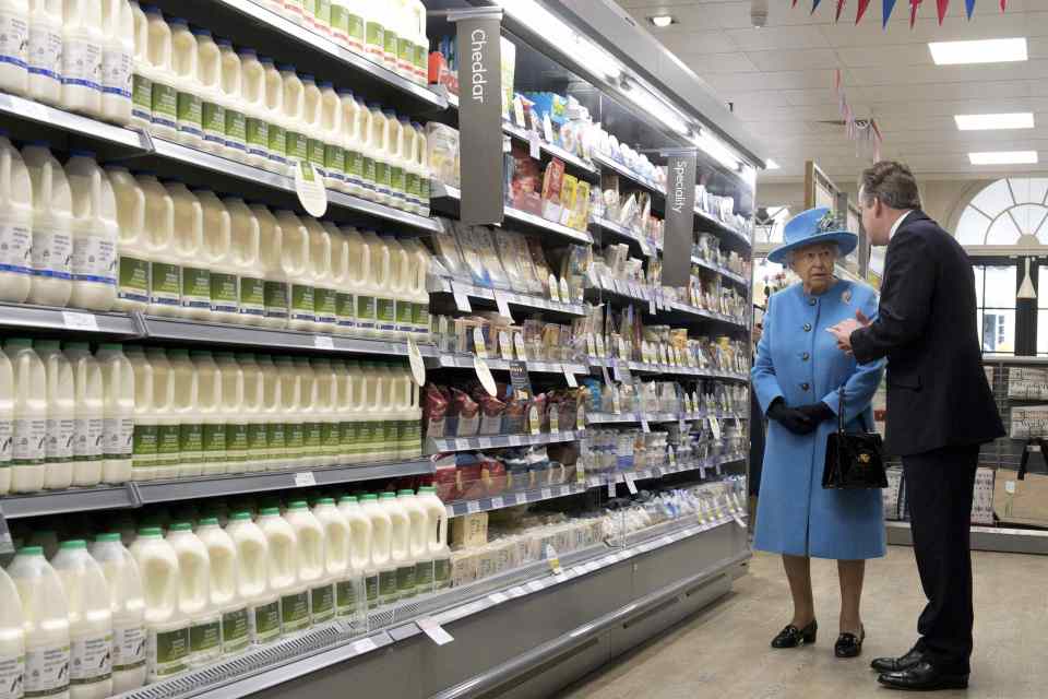  Queen Elizabeth talks with Waitrose Marketing Director Rupert Thomas as she looks around a Waitrose supermarket