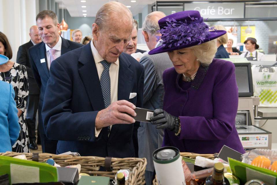  The Duke of Edinburgh and the Duchess of Cornwall inspect their "goodie bags", two of which were full of dog treats