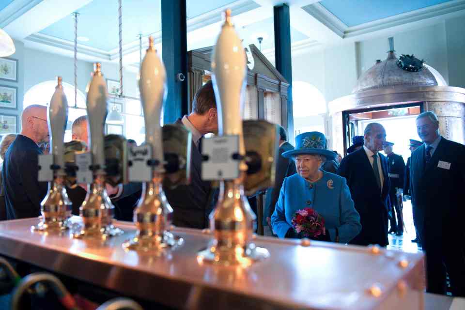  The Queen arrives in the pub and approaches the bar, where Camilla showed off her pint pouring skills