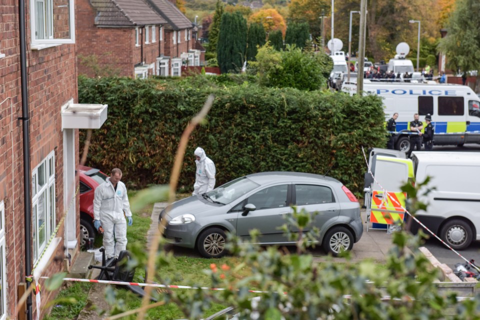  Forensic teams work at the house where two youngsters died in a house fire this morning