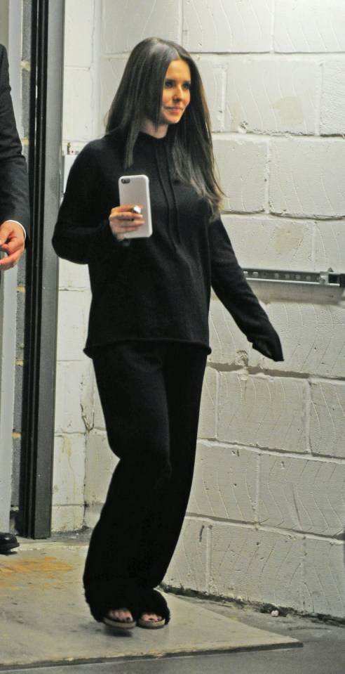  Clutching her phone, Cheryl looked happy as she walked to her waiting car