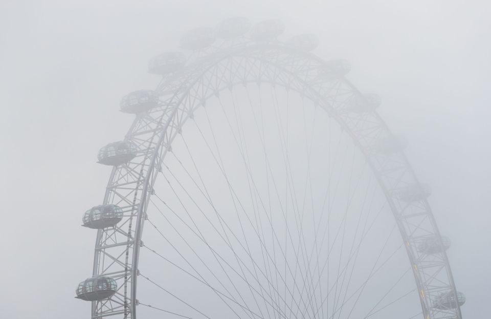  The London Eye seen through thick fog as a balmy October gives way to a freezing November