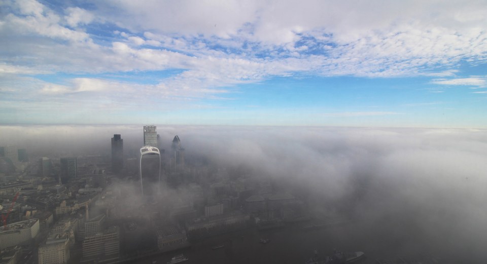  London's skyline is hard to make out through the thick autumnal mist as seen from The Shard this morning