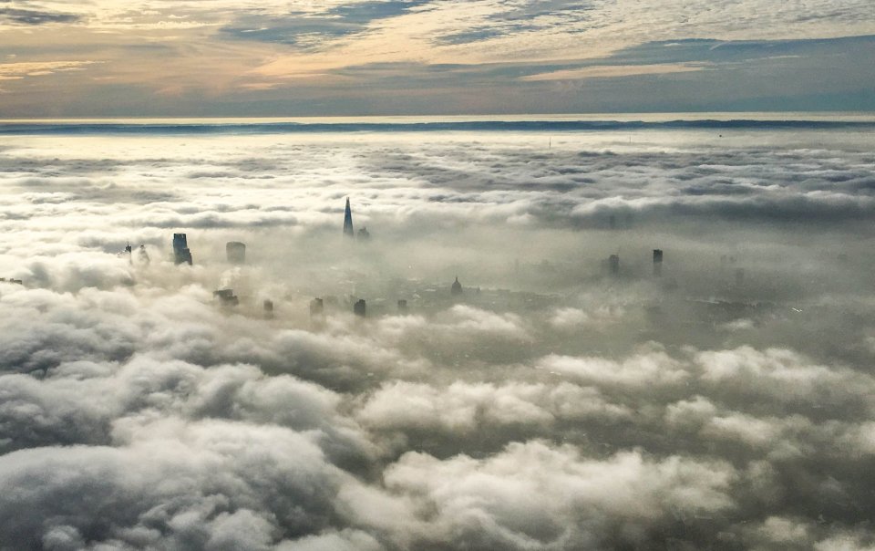  London's tallest buildings poke through low cloud and fog as seen from a helicopter this morning