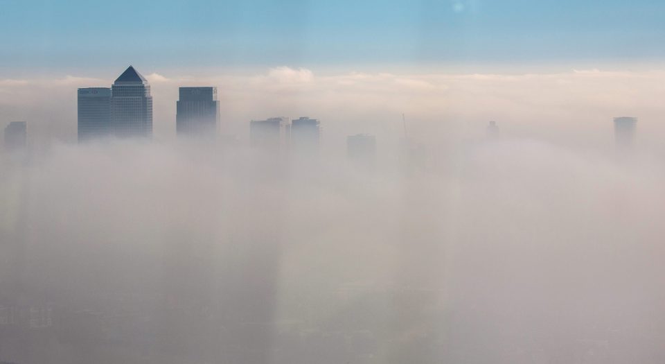  Only the top of the skyscrapers at Canary Wharf are visible above the blanket of fog over London today, as seen from the View at the Shard