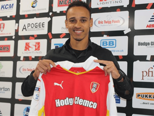  Peter Odemwingie holds up a Rotherham shirt after signing late today