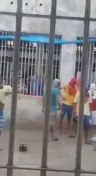 The horrifying moment Brazilian inmates behead a prisoner... and play football with his HEAD