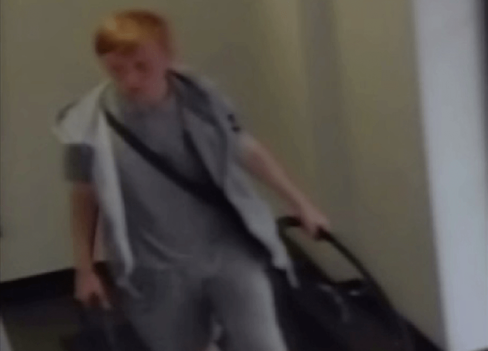  The third suspect is a white teenager with short ginger hair, a black shoulder bag and wearing a grey hooded top over a grey t-shirt, grey shorts and black trainers