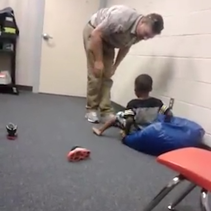  The teacher pushes the boy on the bean bag again