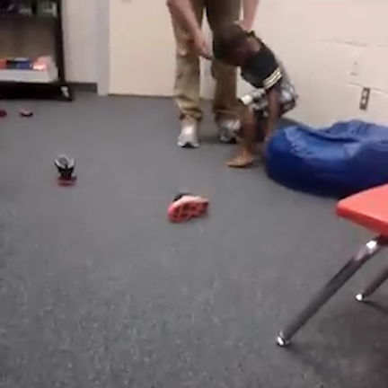  The teacher drags the boy back up before repeating the shocking abuse