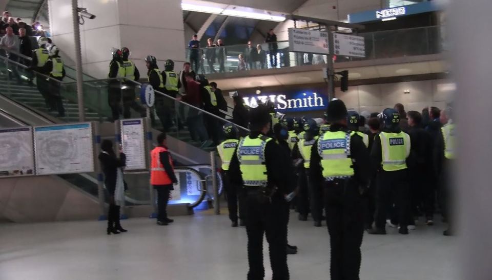  Fans are escorted by the police out of the stadium