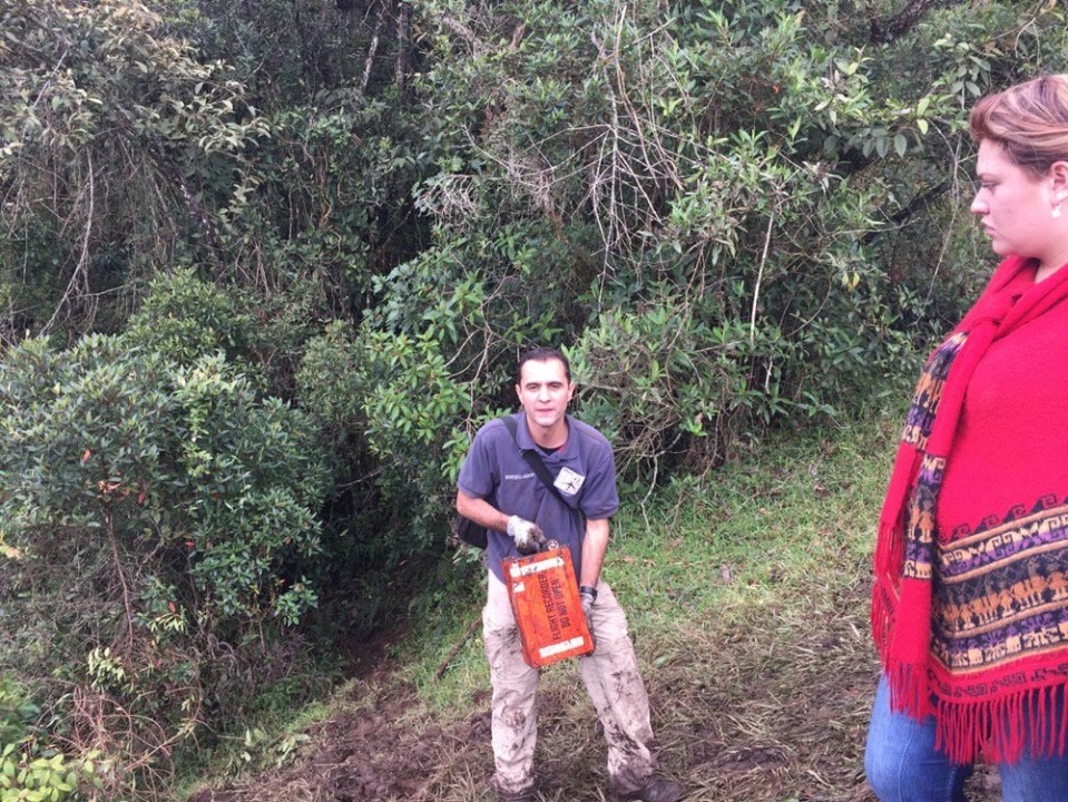  A rescue worker holds up one of the plane's black box deep in the Colombian jungle