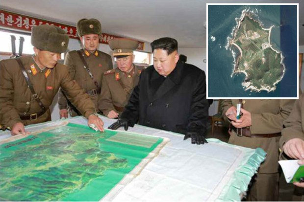 This photograph shows Kim examining a military map of the strategic island