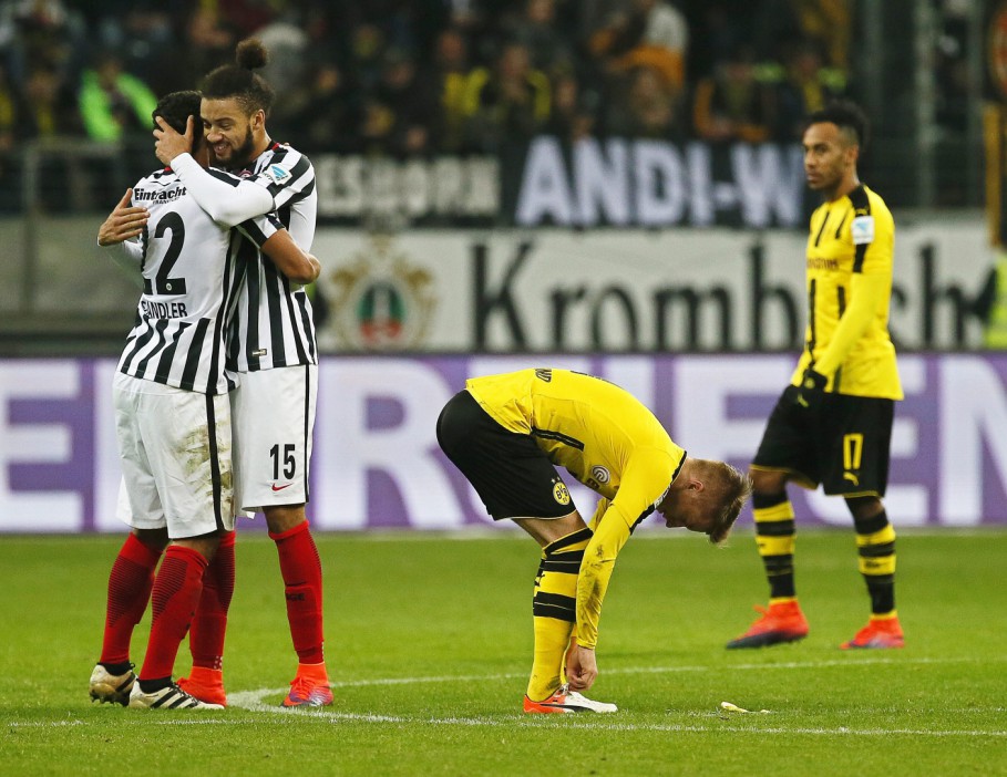  Frankfurt players celebrate next to dejected Dortmund stars Pierre-Emerick Aubameyang and Marco Reus