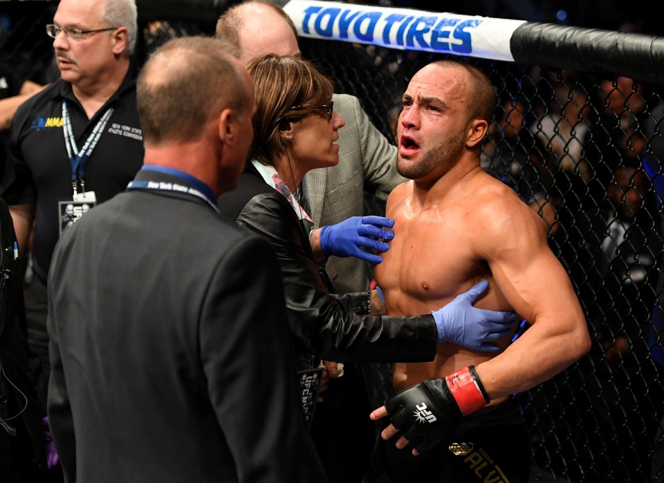  Stunned: Eddie Alvarez is checked over by the medics after his knockout loss to Conor McGregor at UFC 205