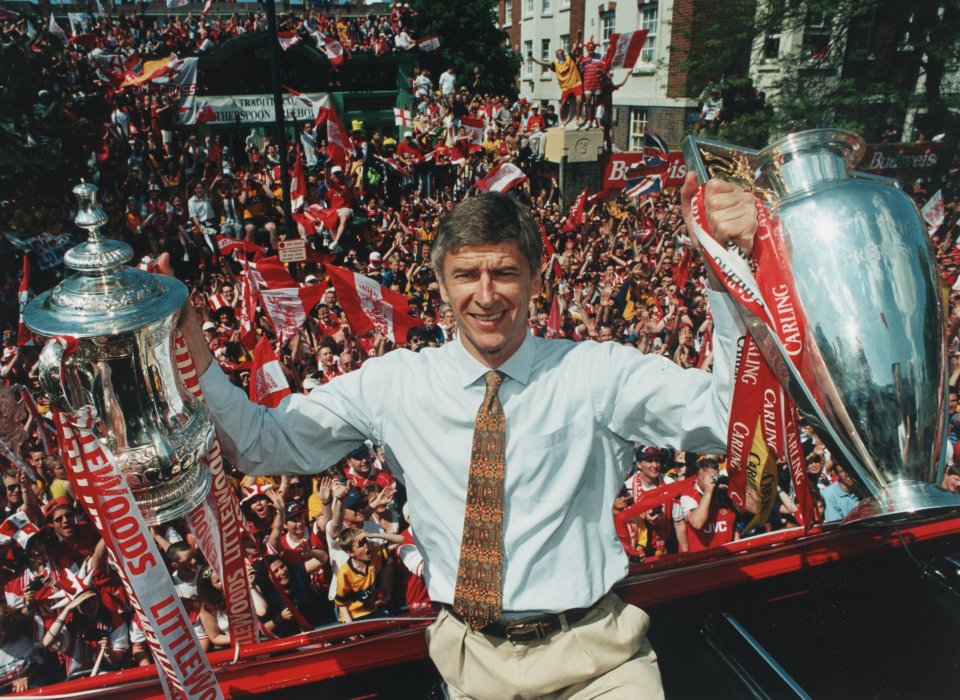  Arsene Wenger shows off the league and FA Cup double he won with Arsenal in 1998