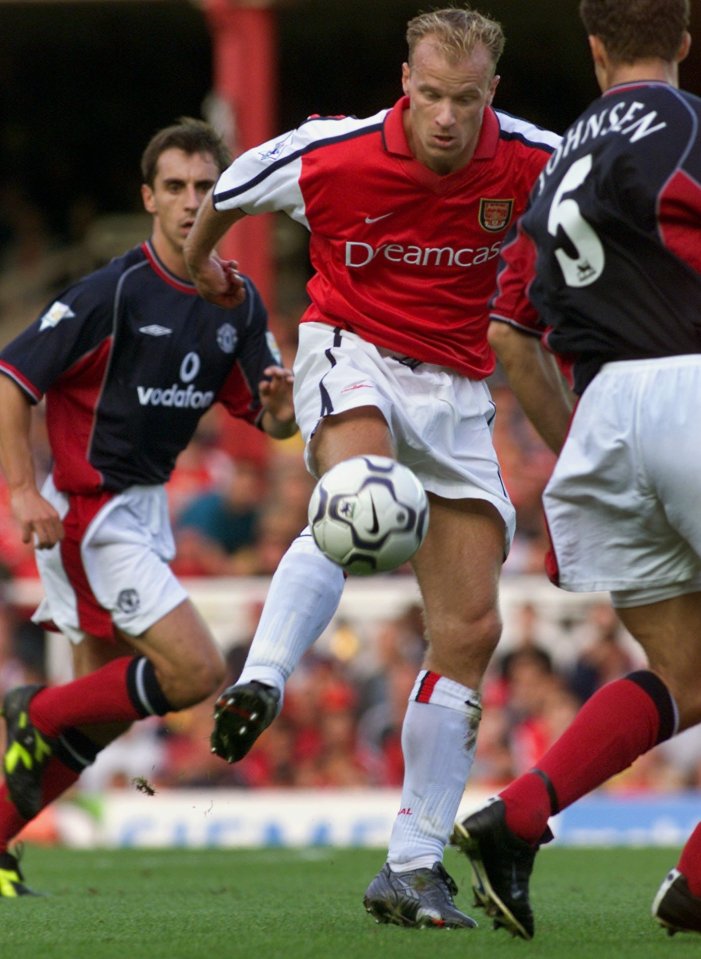  Neville watches on as Dutch master Dennis Bergkamp goes through for Arsenal