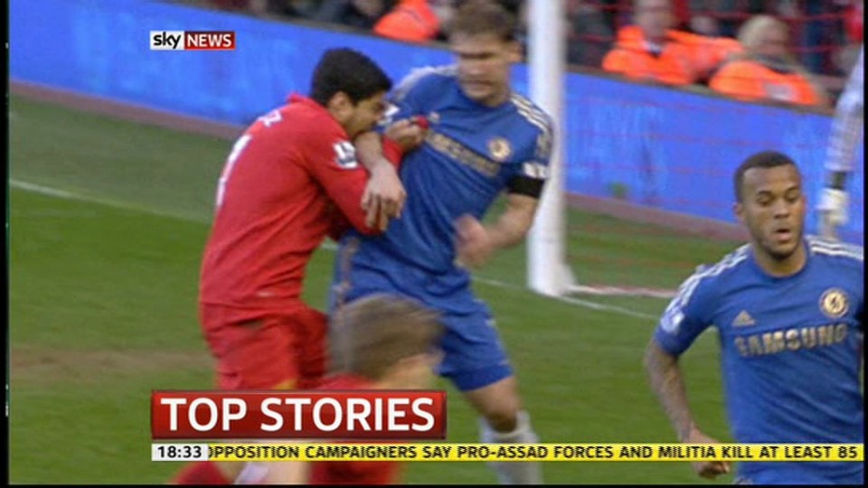  This shot shows the moment Suarez loses his mind again and bites an opposition player