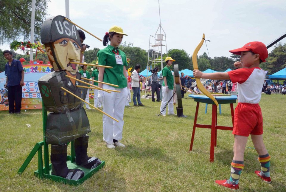  A kid shoots an arrow at an effigy of a U.S. soldier at a popular amusement park in Pyongyang