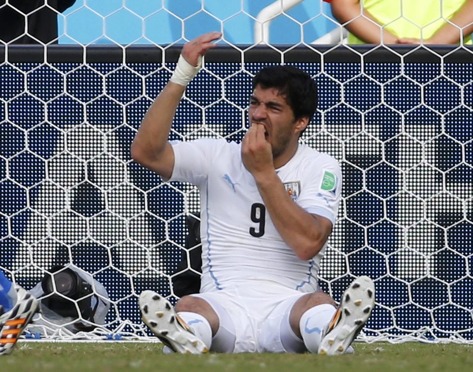  Suarez almost appears as if he is demanding a penalty after his shocking lunge at Chiellini