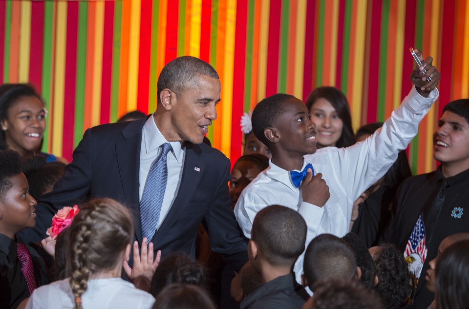  A student takes a selfie after Obama makes a surprise visit to the White House Talent Show at the White House in Washington