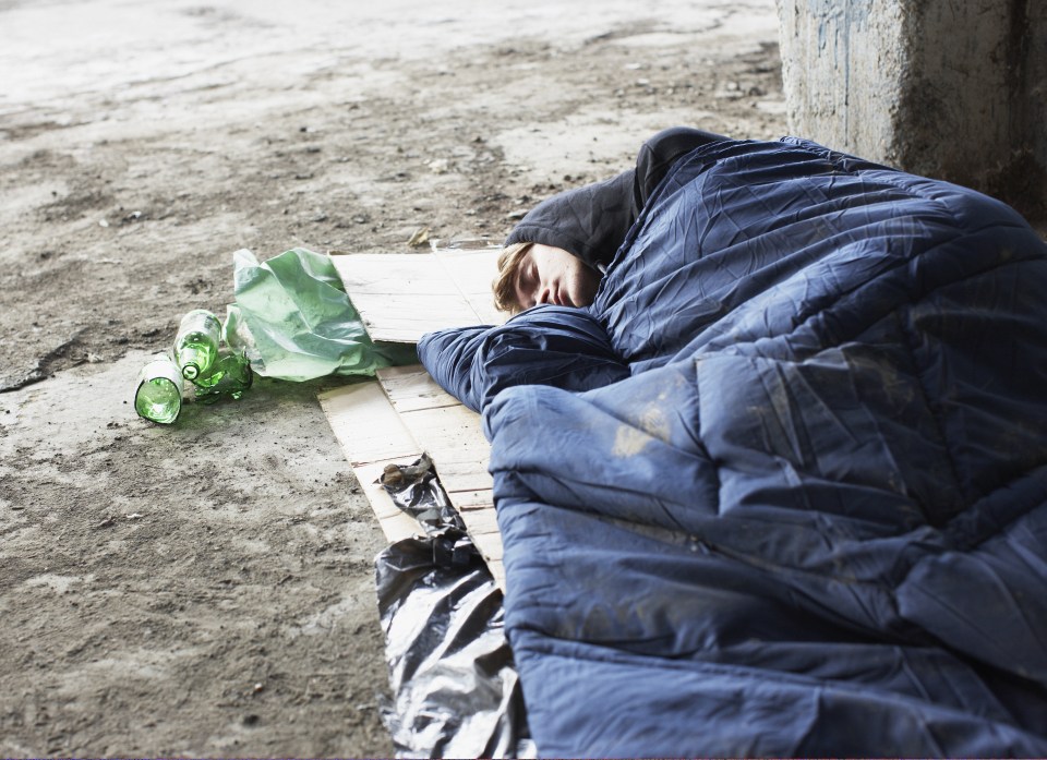 A homeless person sleeps rough on the streets of London