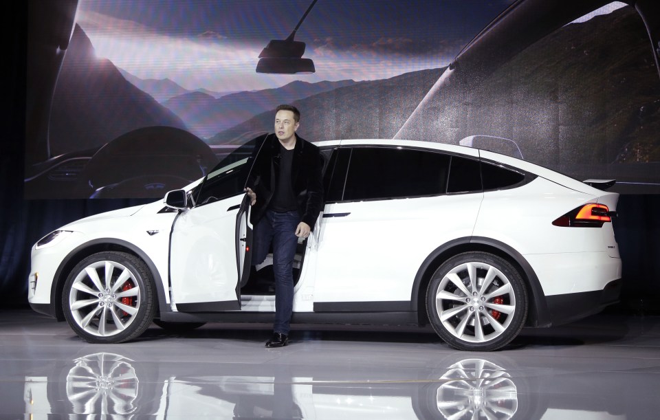  Elon Musk stands with the semi-autonomous Tesla Model X in 2016