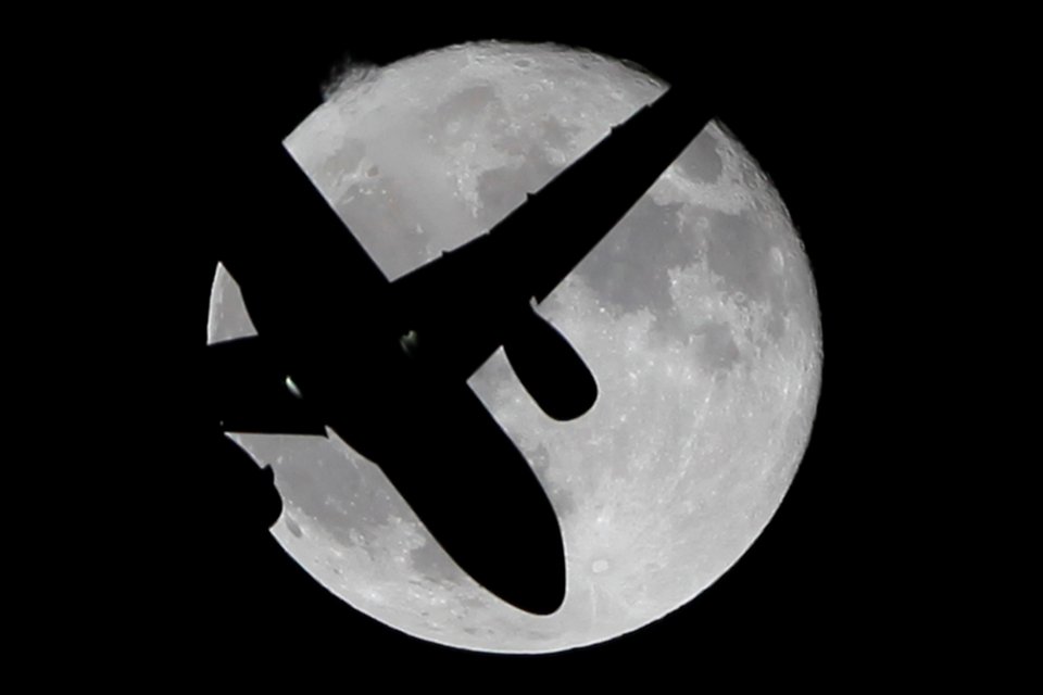  A passenger jet flies past a supermoon in southern Spain last month