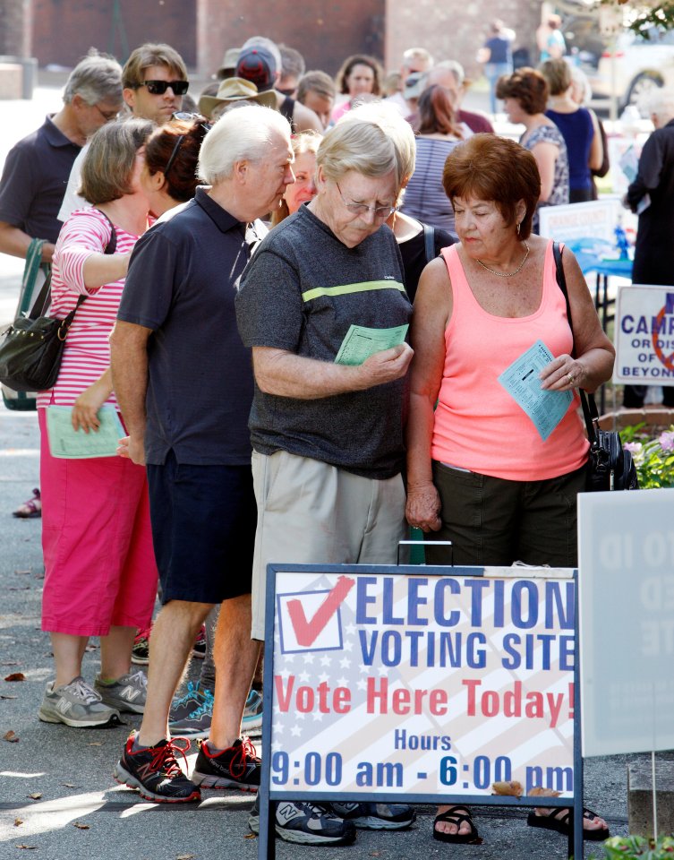 Decision time... A couple wait in a line to cast their ballot at a crowded polling station in Carrboro, North Carolina