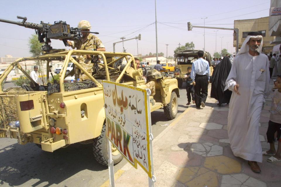  A British army patrol drives through the streets of the southern Iraqi town of Amara