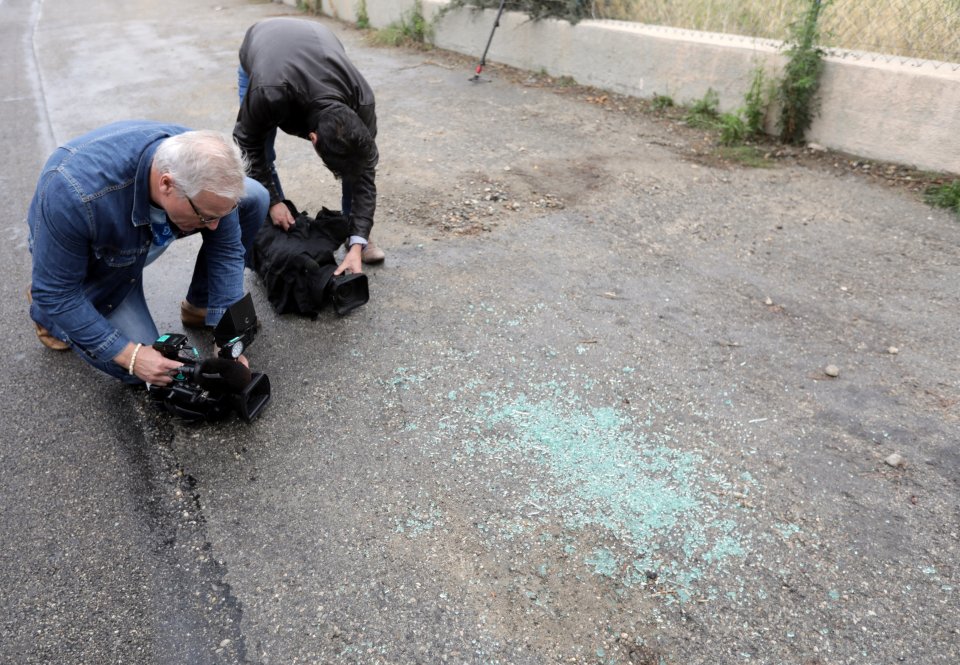  French news reporters take pictures near to the spot where Ms Veyrac was spotted bound and gagged in a van