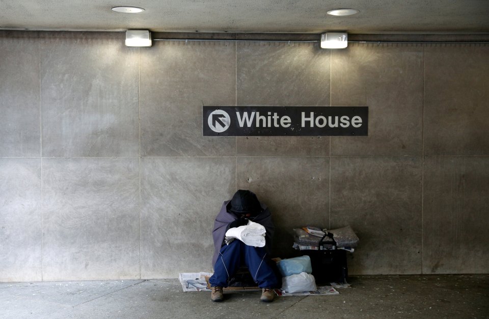  A homeless person tries to stay warm at the entrance of a subway station near the White House in Washington