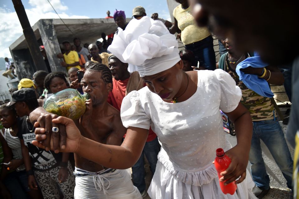  A reveller can be seen swigging rum as the celebrations carry on through the day