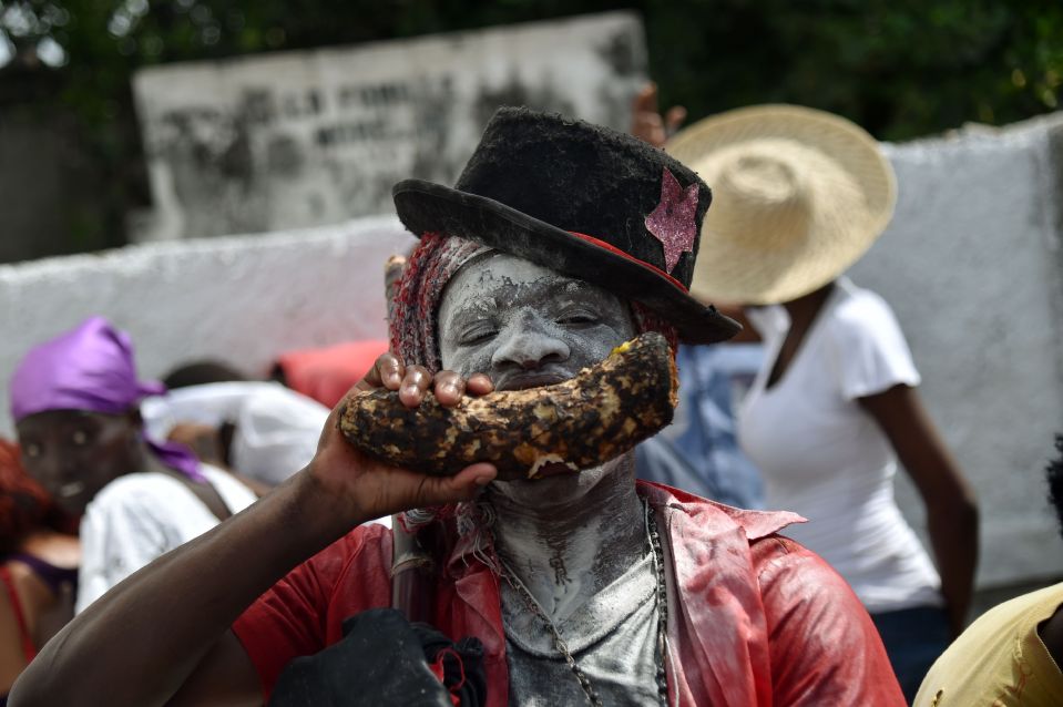  One spiritual follower appears to be chewing on a chunk of wood during the festivities