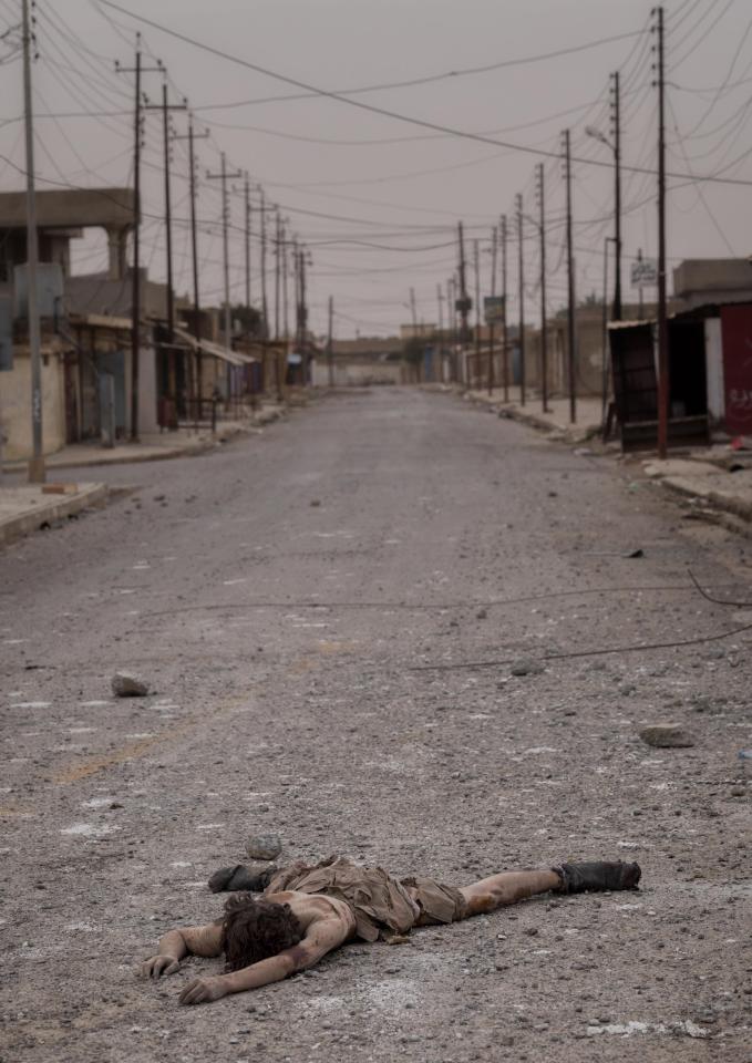  A dead body of a young ISIS fighter boy lies in the vacant street of Shora